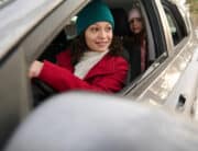 Holiday Car Inspection Guide by Girlington Garage | South Burlington Auto Experts. Image of mom driving kids in car during winter.