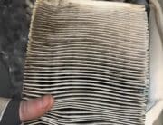 Car maintenance services near me in South Burlington, VT with Girlington Garage. Image of dirty air filter that was in a vehicle that came into the shop for regular scheduled car maintenance.