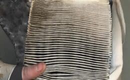 Car maintenance services near me in South Burlington, VT with Girlington Garage. Image of dirty air filter that was in a vehicle that came into the shop for regular scheduled car maintenance.